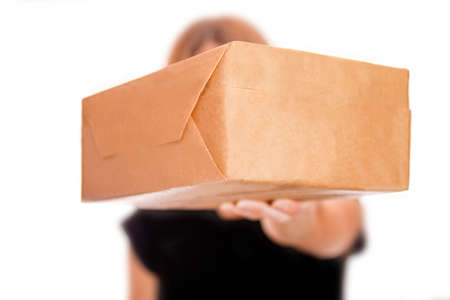 Beautiful gift in the hands of a girl on a white backgroundの写真素材