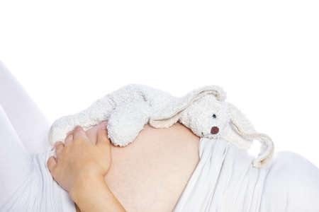 Happy pregnant girl lies on white background