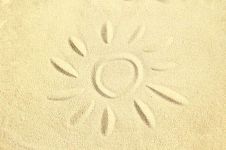 drawing on the sand sun and waves summerの写真素材