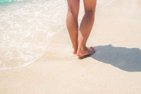 beautiful traces with feet near the sea on nature backgroundの写真素材