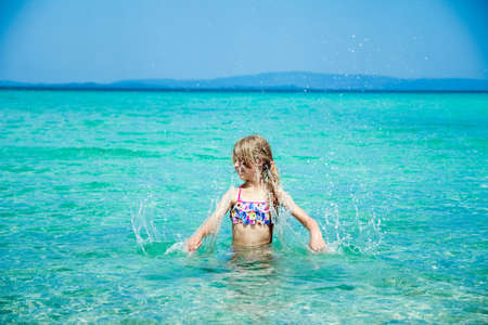 happy child at sea in greece plays in natureの写真素材