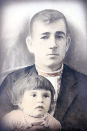 Old retro portrait of a man guy with a child in the studio