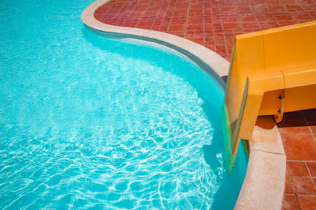 Stylishly interesting water slide in the pool near the sea on nature backgroundの写真素材