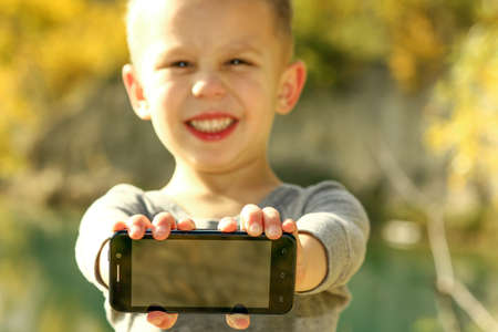 happy little boy with phone