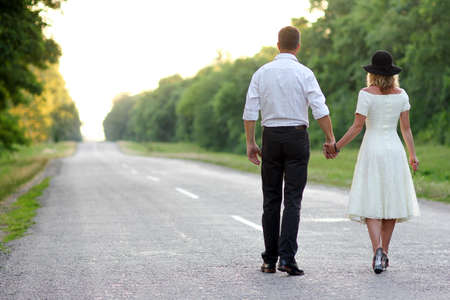 retro love couple walking down the roadの写真素材