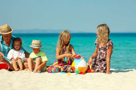 Happy family with children play on the beach on Greece in summer vacationの写真素材