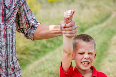 Hands of parent and screaming child concept at pirodev park