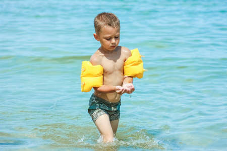 Happy child by the sea in nature in the park journeyの写真素材