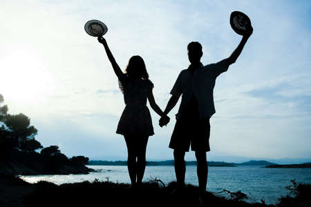 happy couple by the sea on nature in travel silhouette