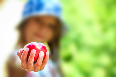 happy child with apple on nature in the garden backgroundの写真素材