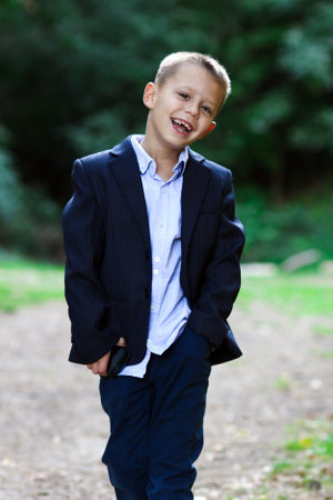 Happy child business men emotions on nature in the park travel concept happynessの写真素材