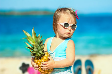 Pineapple in the hands of a man by the sea in nature on a journey background