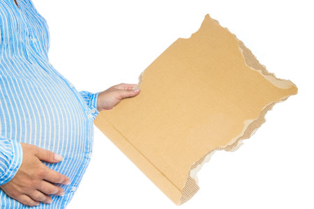 Happy pregnant girl lies on white backgroundの写真素材