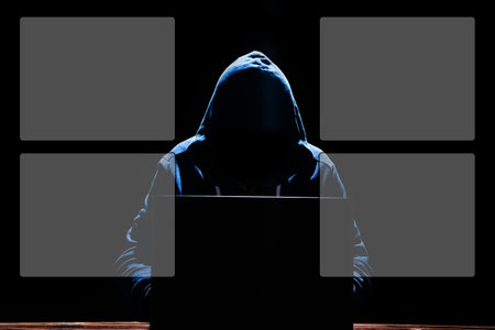 Hacker with laptop sits at a table and abstract binary code. Business life threat virtual programs.