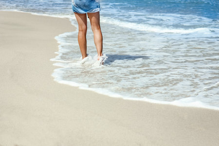 Feet and footprints by the seashore in nature travel vacation background