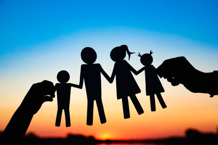 silhouette family, including his father, mother and two children in the hands ofの写真素材