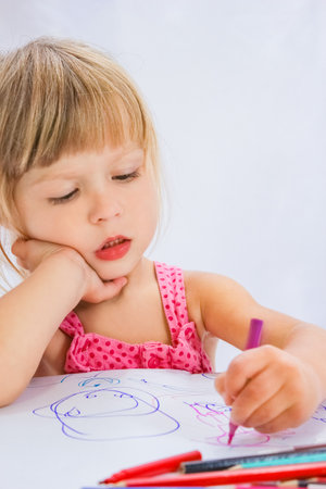 happy child draws on a white backgroundの写真素材