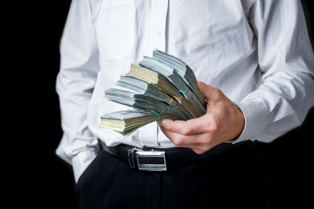 money in the hands of a businessman in a crisis raising business concept bank worker