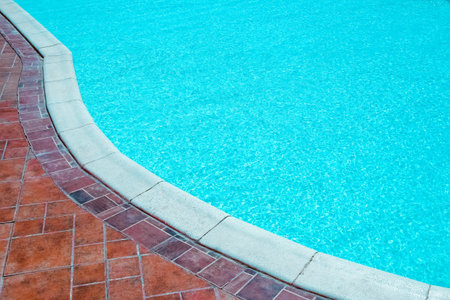 Beautiful swimming pool at the seaside hotel in park background