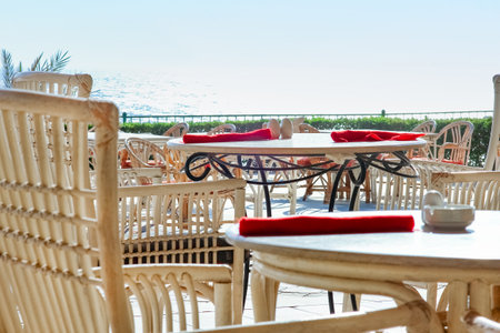 Beautifully stylish table chairs for eating people at sea backgroundの写真素材