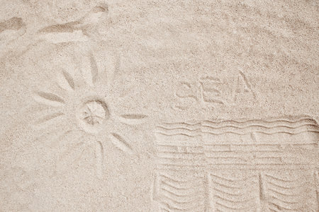 Beautiful drawing on the sand of the sea backgroundの写真素材
