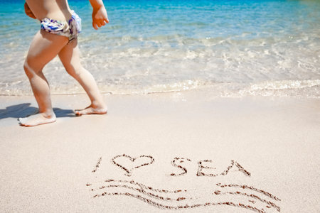Happy child playing on the sea backgroundの写真素材