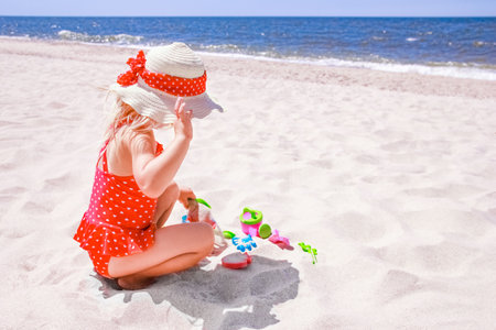 Happy baby girl on the sea in the summer on the natureの写真素材