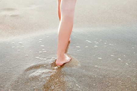 stylish beautiful legs with traces of the sea in the summer on the natureの写真素材