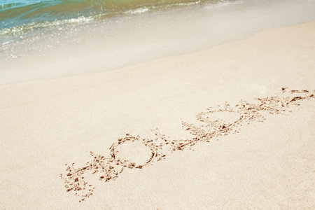 beautiful drawings inscription on the sand of the sea in the summer on the natureの写真素材
