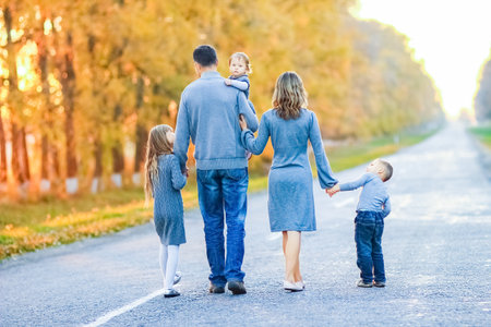 Happy family walking along the road trip in the parkの写真素材