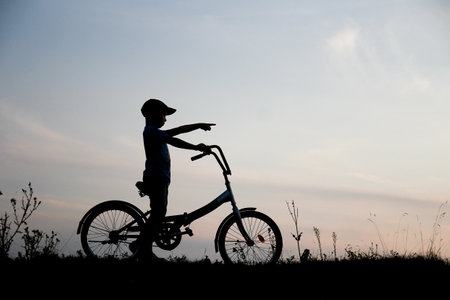 silhouette Happy child and bike concept in park summer sportの写真素材