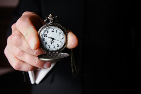 pocket watch in the hands of a man
