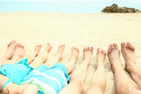 beautiful legs in the sand of the sea greece backgroundの写真素材