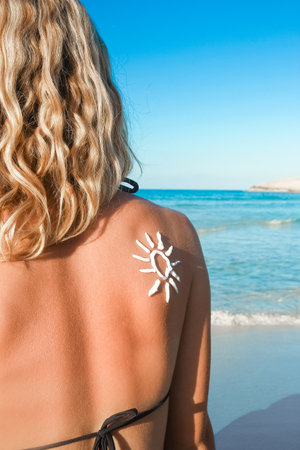 happy girl with the sun on her back by the sea in the natureの写真素材