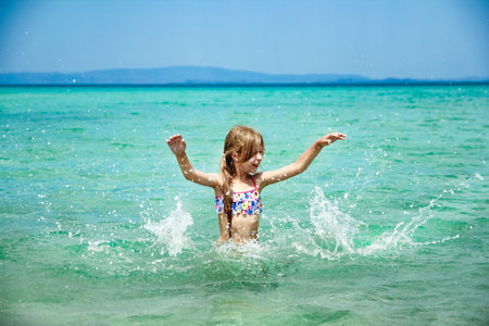 happy child at sea in greece plays in natureの写真素材