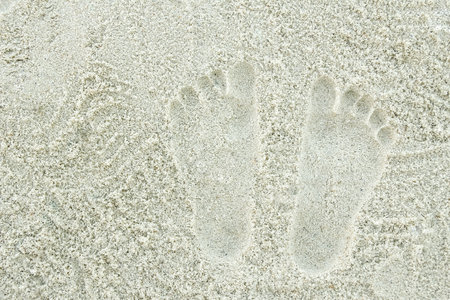 beautiful pattern on the sea sand on nature backgroundの写真素材