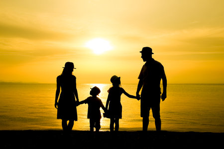 happy family in nature by the sea on a trip silhouetteの写真素材