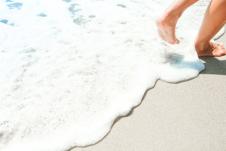 Feet and footprints by the seashore in nature travel vacation backgroundの写真素材