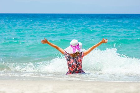 Happy girl on the shore of the sea in travel vacationの写真素材