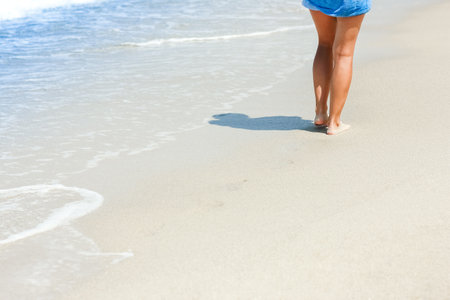 Feet and footprints by the seashore in nature travel vacation backgroundの写真素材