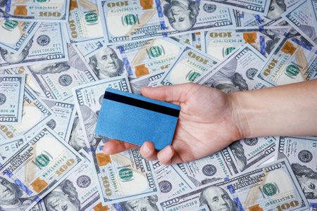 credit card in hands with dollars concept on background in travel