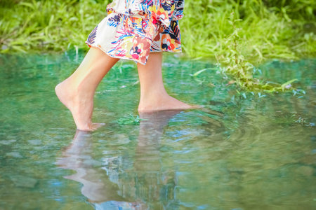 feet of happy girl on nature weekend in park travelの写真素材