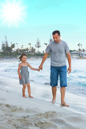 happy parent with a child by the sea in the open airの写真素材