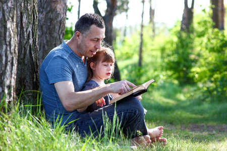 father and child reading the bible concept familyの写真素材