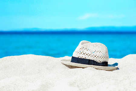 hat on the sand by the sea in nature weekend travelの写真素材