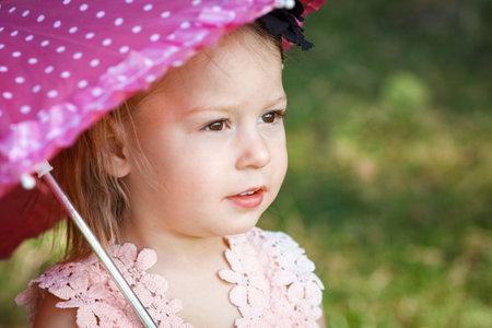 happy child with an umbrella in the park on the natureの写真素材