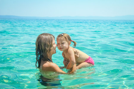 happy parent with child at sea in greeceの写真素材
