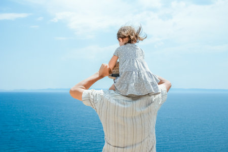 hands of happy parents and children at sea in travel background in greeceの写真素材