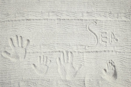 drawing on the sand by the sea travel backgroundの写真素材