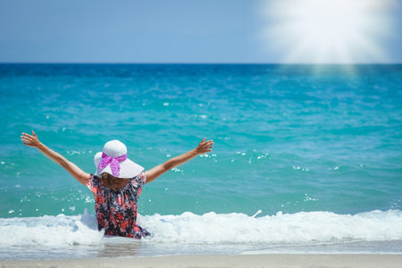 Happy girl on the shore of the sea in travel vacationの写真素材